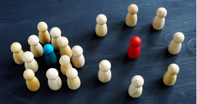 Introvert and extrovert concept with wooden figurines on desk