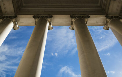 Building column on a government building with a beautiful blue sky.