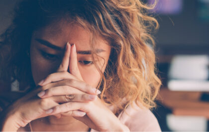 Woman leaning on hands on table