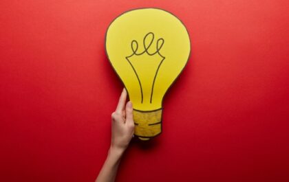 Person's hand holding a drawn out lightbulb