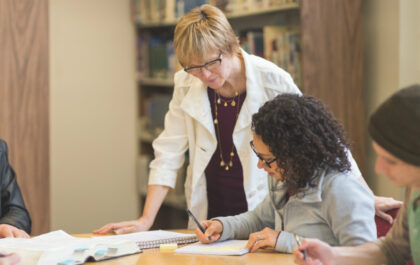 Teacher looking over student work