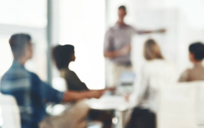 A meeting with individuals blurred out by window