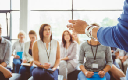 Group of people listening to a speaker