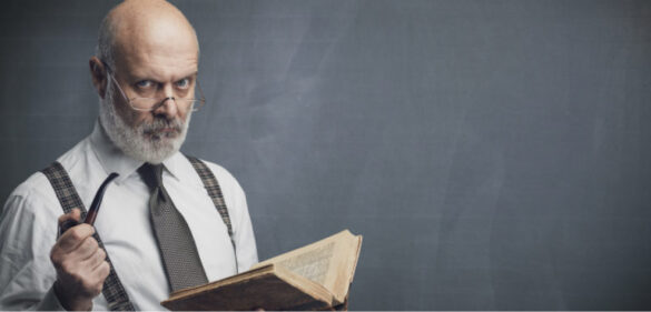 Older librarian holds book with stern face