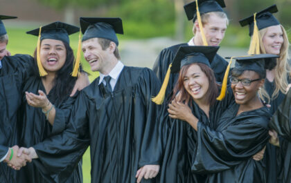 group-of-college-students-in-caps-and-gowns-laughing-having-fun