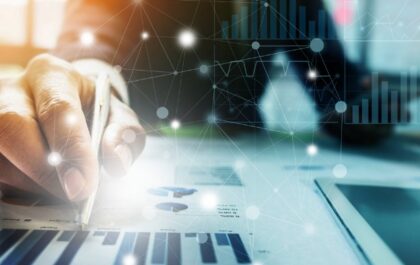 person-working-at-desk-on-data-with-graphs-and-data-imagery
