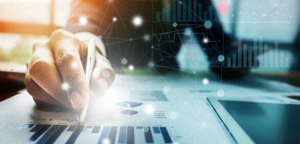 person-working-at-desk-on-data-with-graphs-and-data-imagery