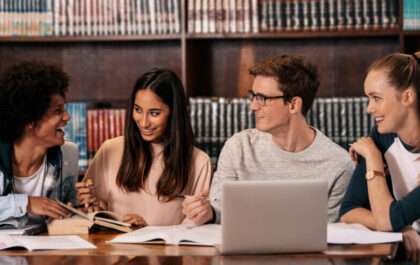 group-of-diverse-students-in-library-conversing
