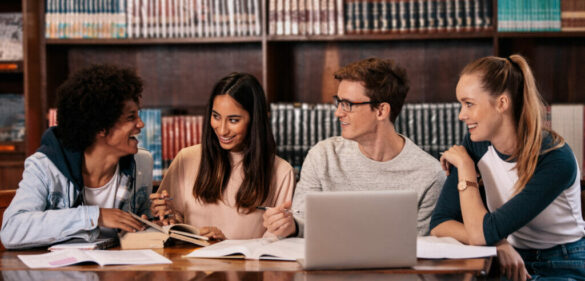 group-of-diverse-students-in-library-conversing