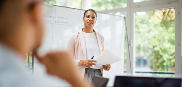 woman-at-front-of-whiteboard-in-classroom-leading