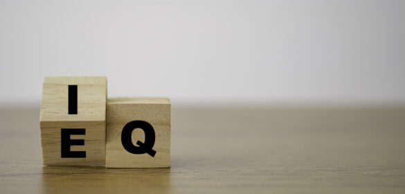 Flipping of EQ to IQ which print screen on wooden cube block. Smart idea and smart emotion concept.