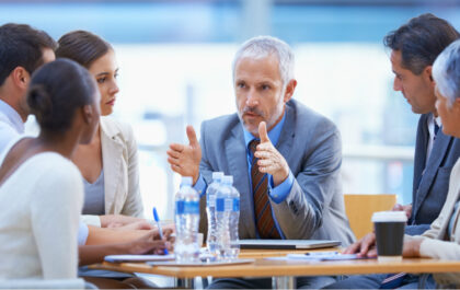 A cropped shot of a businessman sharing an idea with colleagues at a meeting