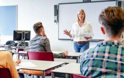 female-educator-standing-in-front-of-classroom-teaching