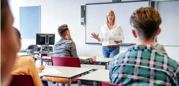 female-educator-standing-in-front-of-classroom-teaching