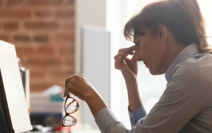 Stressed overworked middle aged businesswoman office worker taking off glasses tired from computer work feeling headache, dry eye strain, bad blurry weak vision eyestrain tension problem concept