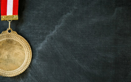Success in education medal in front of blackboard