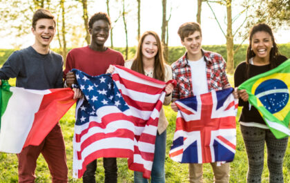group-of-young-diverse-smiling-students-posing-for-a-phot-each-holding-a-flag-of-their-country-of-origin