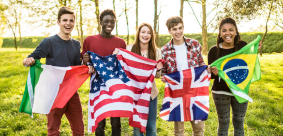 group-of-young-diverse-smiling-students-posing-for-a-phot-each-holding-a-flag-of-their-country-of-origin