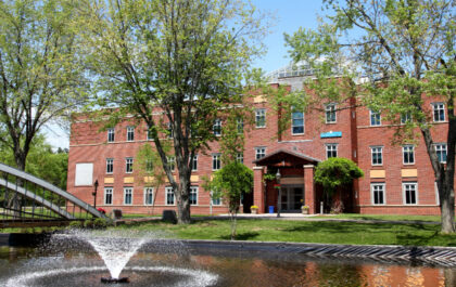 college-campus-with-trees-and-fountain-in-the-foreground