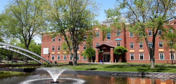 college-campus-with-trees-and-fountain-in-the-foreground